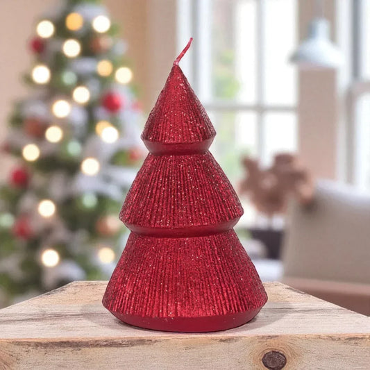 Red glitter Christmas tree candle with tiered design, festive holiday decor on wooden surface