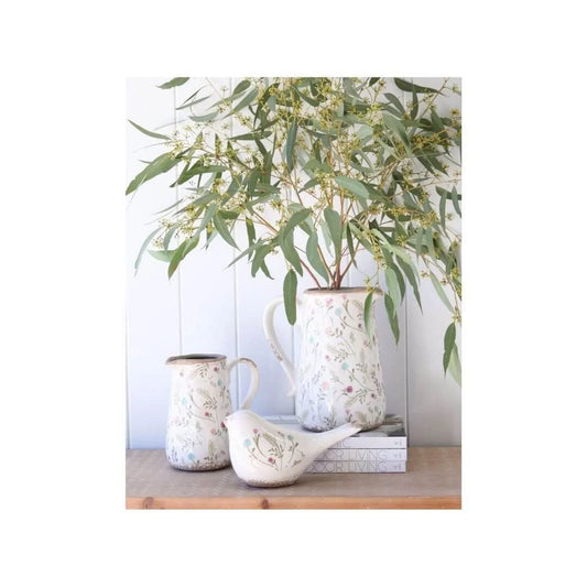 Floral ceramic pitchers and bird figurine with eucalyptus, rustic home decor accents
