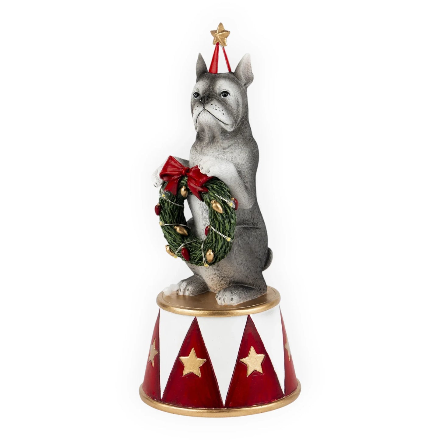 Festive French Bulldog figurine holding Christmas wreath, wearing party hat, on red and white star base