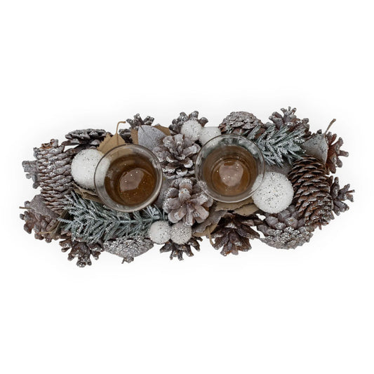 Frosted pinecone centerpiece with glittery ornaments and glass candle holders for holiday home décor