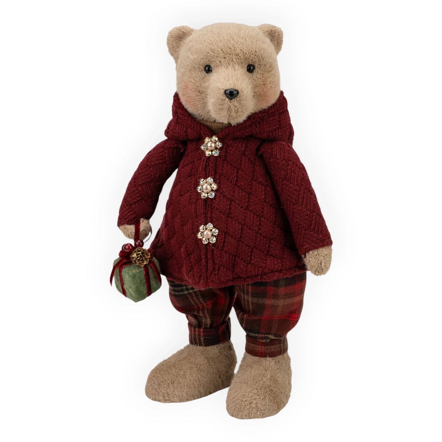Plush teddy bear in burgundy cable knit coat with jeweled buttons, plaid pants, holding green gift ornament