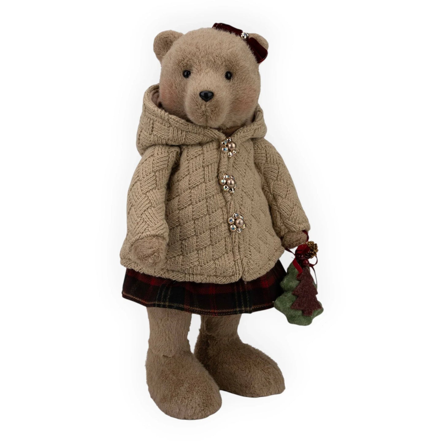 Charming teddy bear in cozy cable knit coat, plaid skirt, holding festive Christmas tree ornament, perfect for holiday home dΓ©cor.