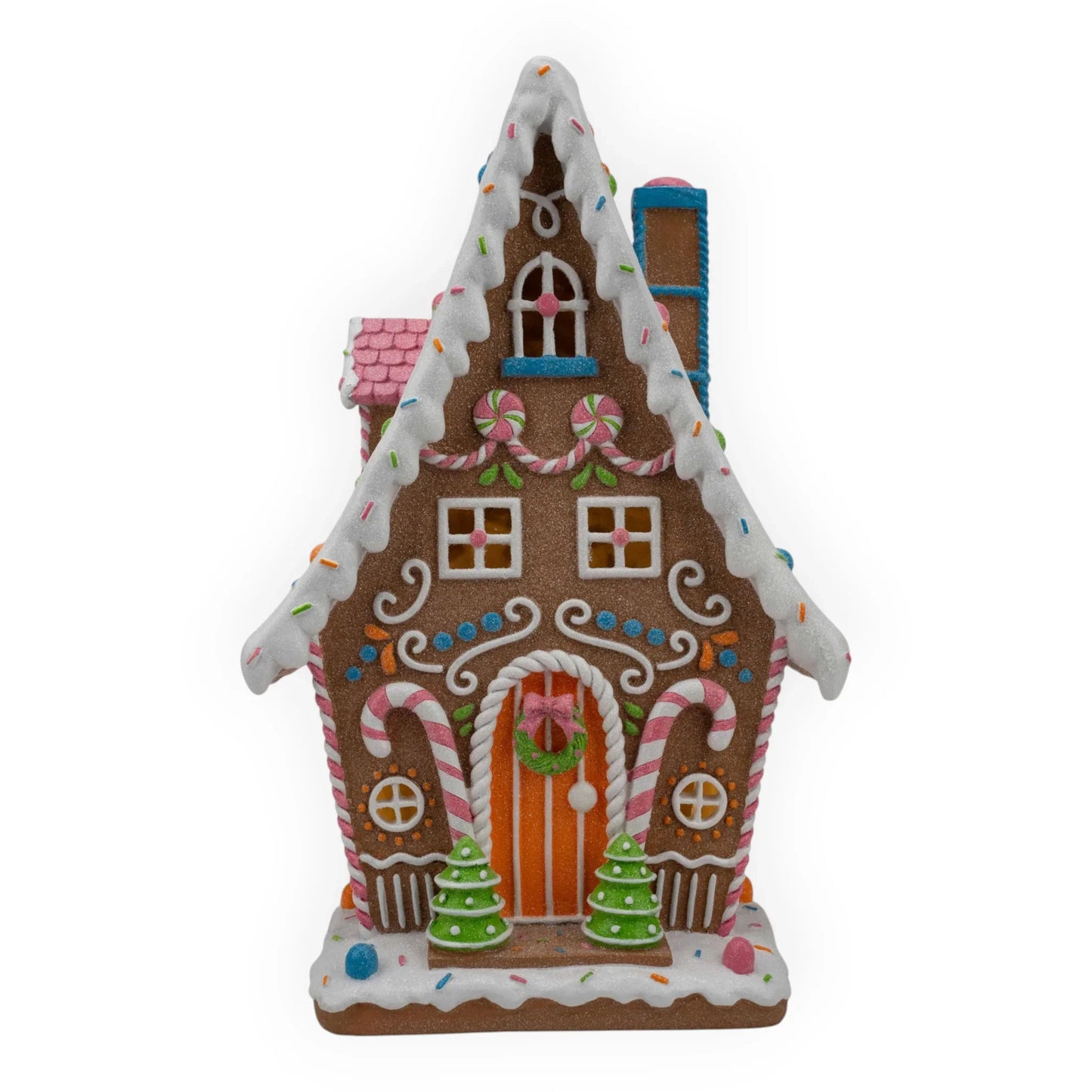 Festive gingerbread house with candy canes, sprinkles, and mini trees for holiday home décor
