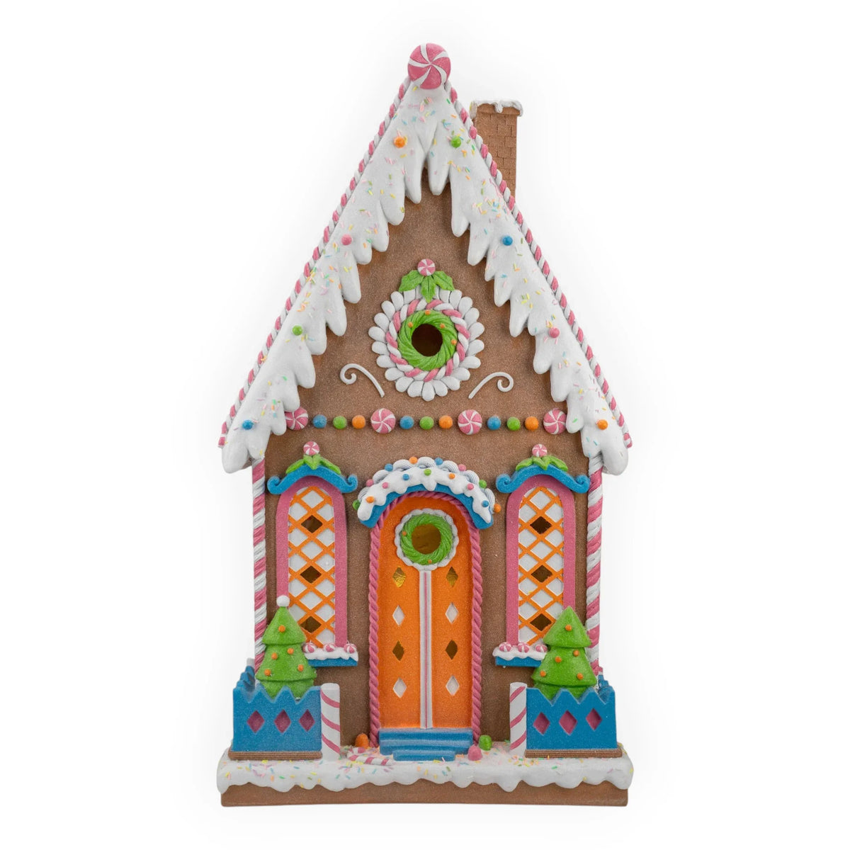 Colorful gingerbread house with candy decorations, wreaths, and festive trees for holiday home dΓ©cor