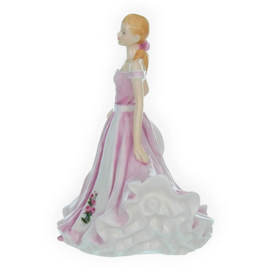 Porcelain figurine of woman in pink gown with rose detail, elegant home décor accent