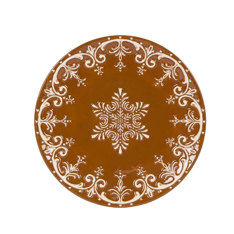 Brown decorative plate with white floral scrollwork and snowflake design, elegant home décor accent