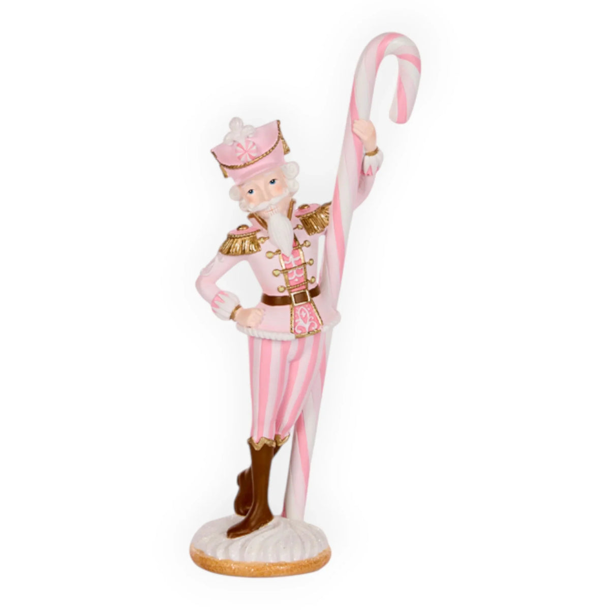 Pink nutcracker soldier figurine holding candy cane, festive holiday decor with striped uniform and gold accents