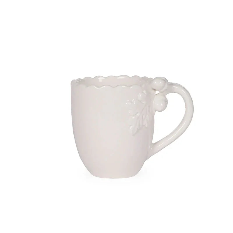 White ceramic mug with scalloped rim and floral handle detail, elegant home décor accent