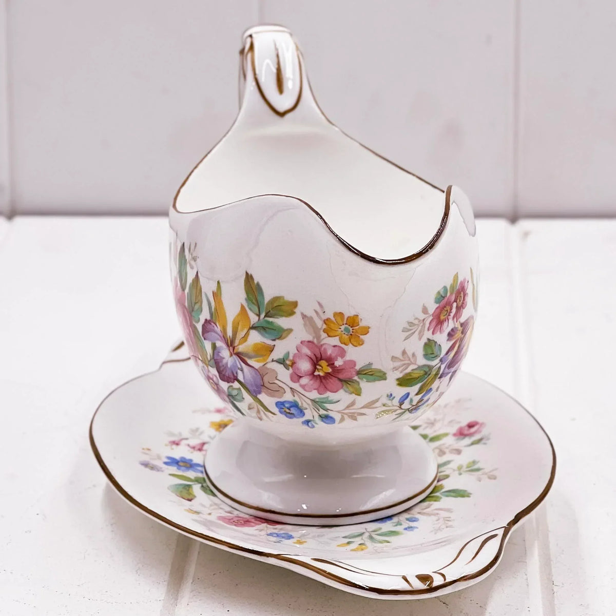 Vintage floral gravy boat with matching saucer, delicate hand-painted flowers and gold trim, elegant homeware