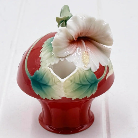 Red ceramic vase with white hibiscus flower and green leaves, vintage home décor accent piece