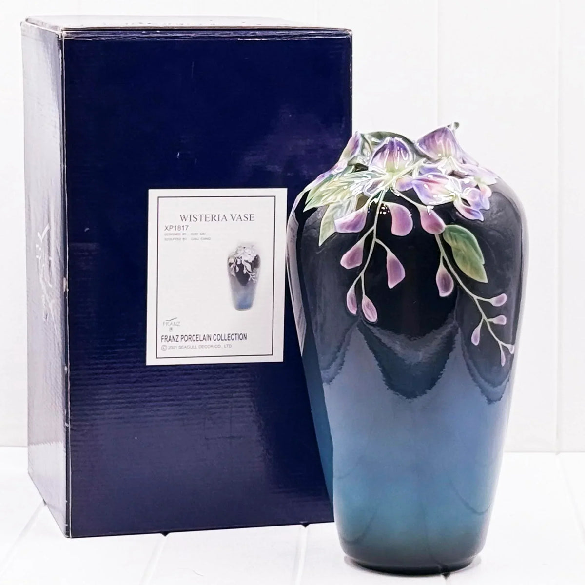 Elegant Wisteria porcelain vase with purple floral design, part of Franz Porcelain Collection, displayed with original box.