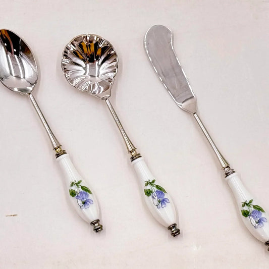 Elegant vintage serving set with floral porcelain handles and silver-toned metal, perfect for home décor