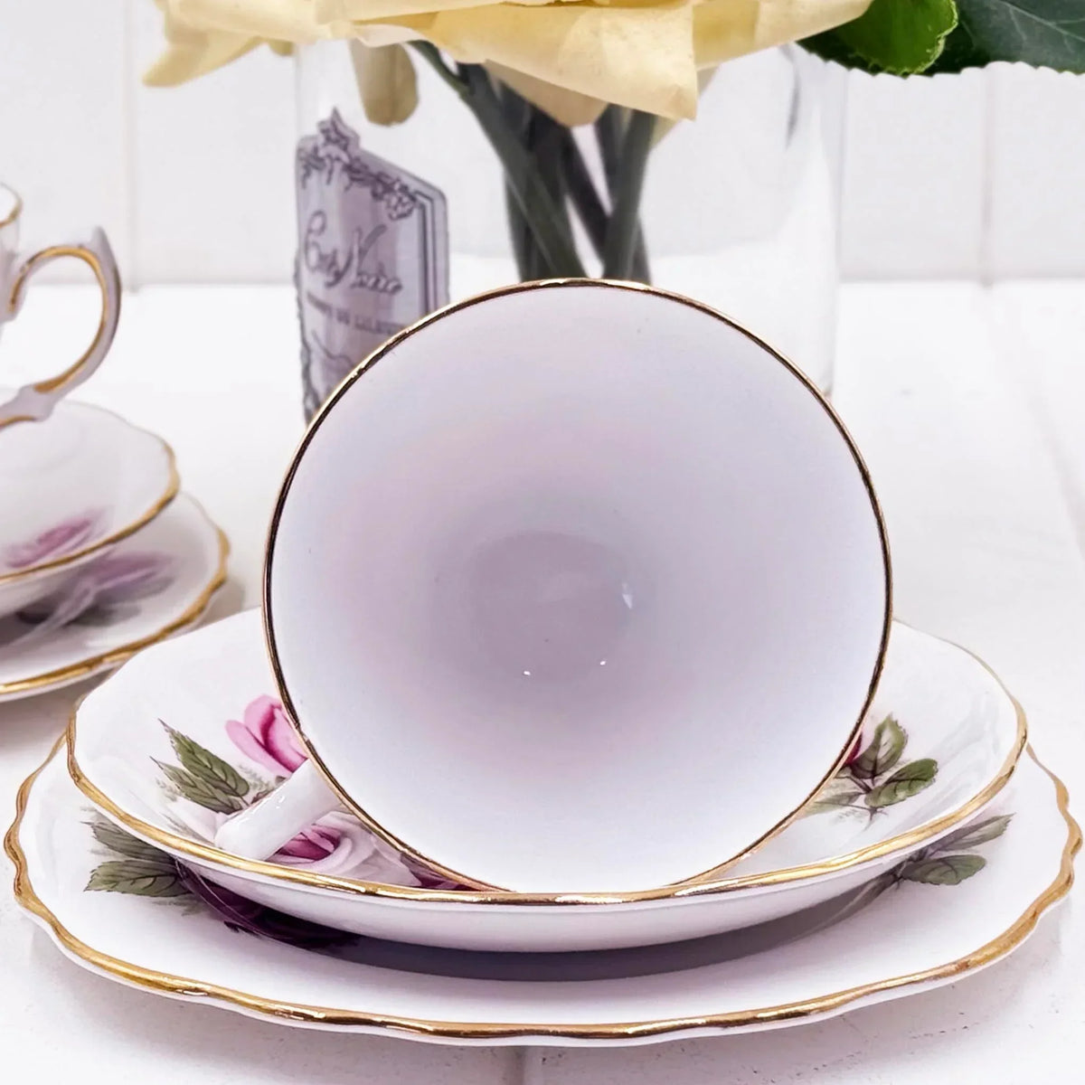 Elegant porcelain teacup with pink rose design and gold trim, perfect for vintage home dรฉcor and afternoon tea settings.
