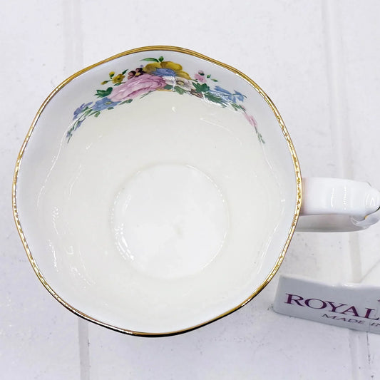 Vintage floral teacup with gold trim, delicate pink and blue flowers, classic porcelain design
