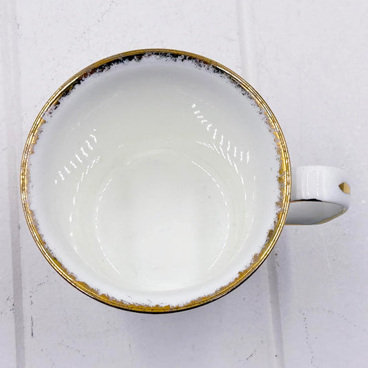 White ceramic cup with gold rim, elegant home decor accessory