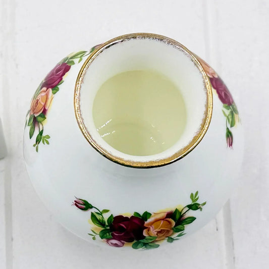 Elegant porcelain vase with hand-painted roses and gold trim, perfect for vintage home décor