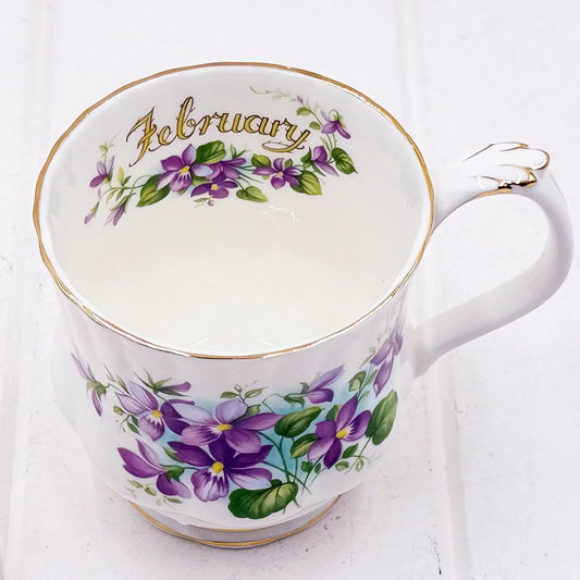 Elegant February floral teacup with purple violets and gold trim, vintage home décor accent