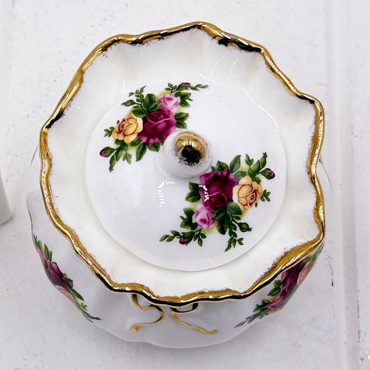 Elegant porcelain trinket box with gold trim and hand-painted rose floral design, vintage home decor