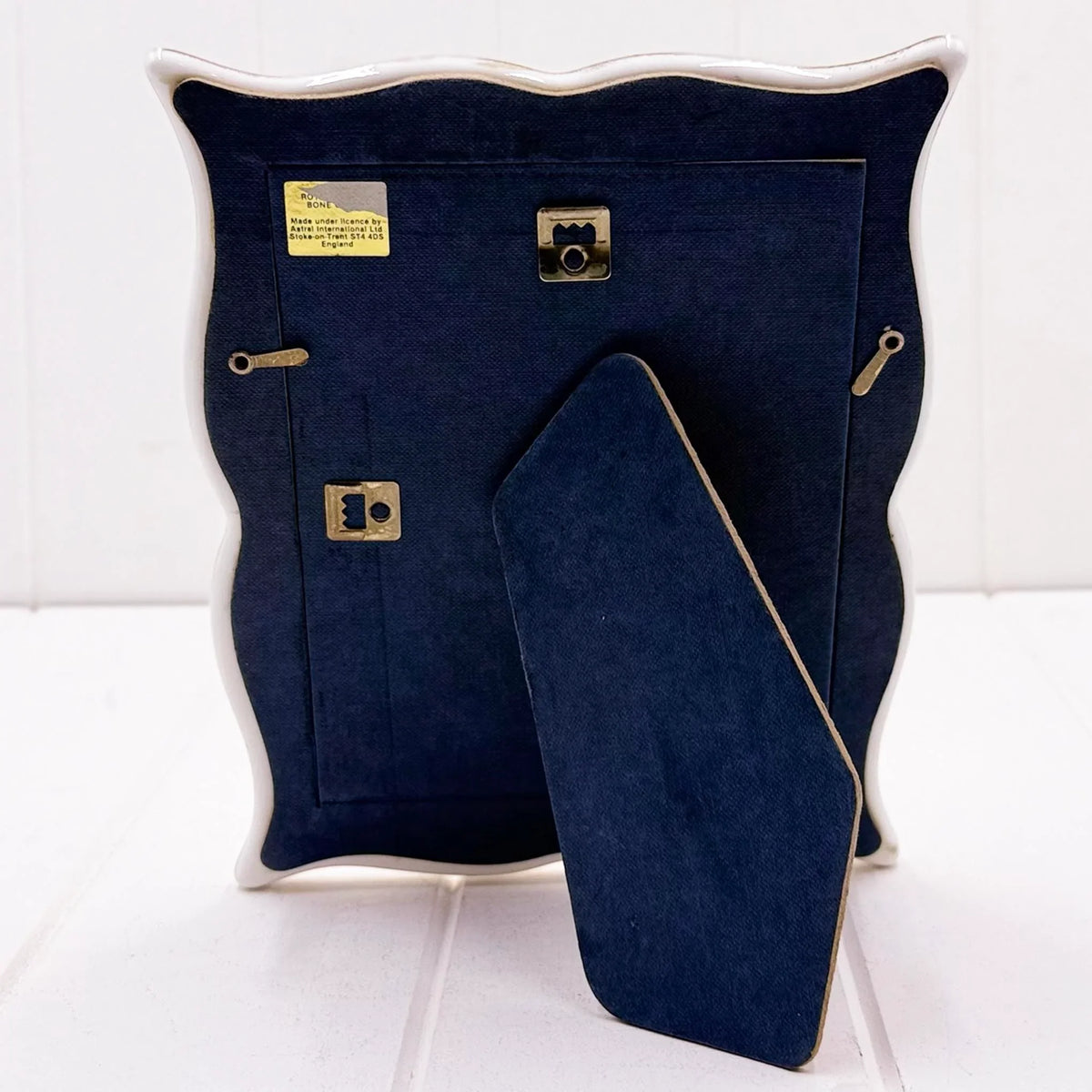 Elegant navy velvet-backed photo frame with gold hardware, vintage-style home décor accent