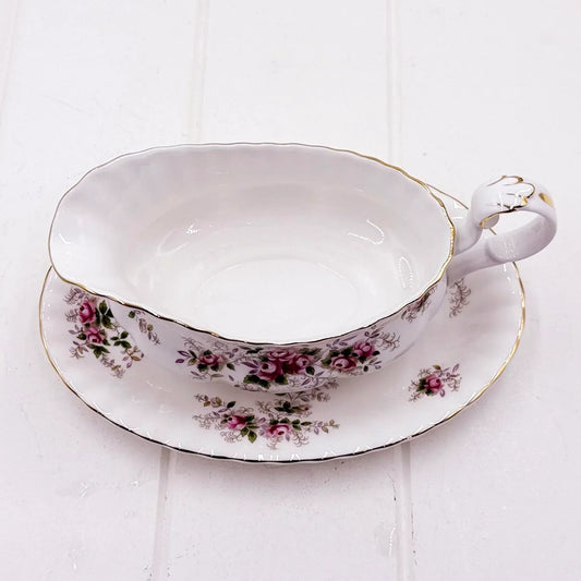 Elegant vintage teacup and saucer with pink rose floral pattern and gold trim, perfect for classic home décor