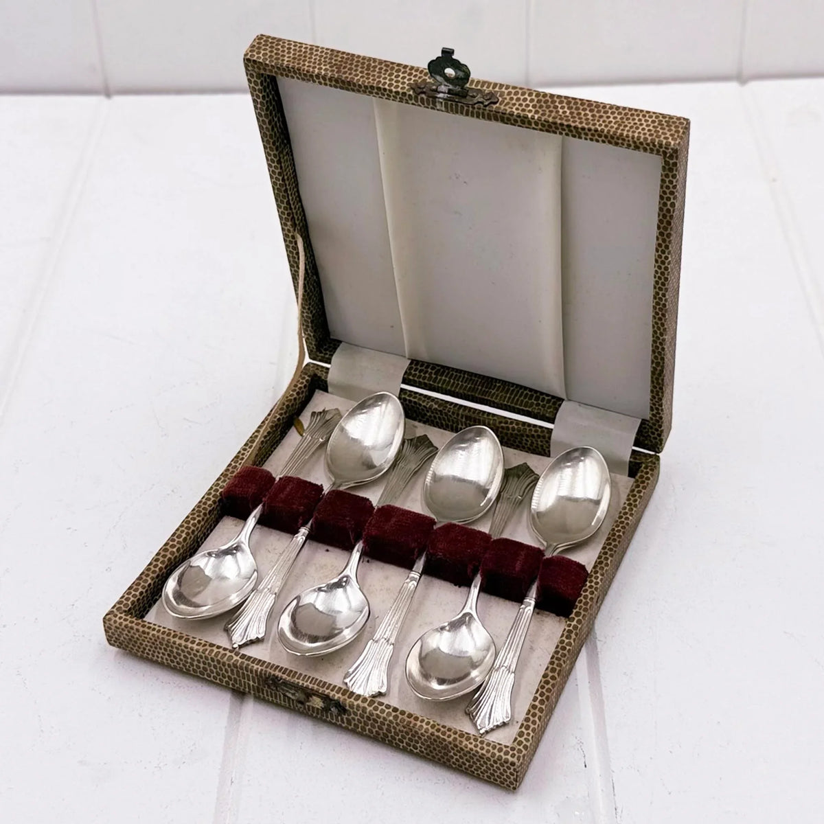 Vintage silver spoons in textured case with red velvet lining, elegant home decor accessory