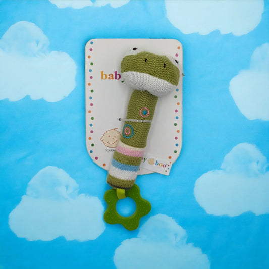 Knitted green frog baby rattle with teether, soft toy for infants, cloud background
