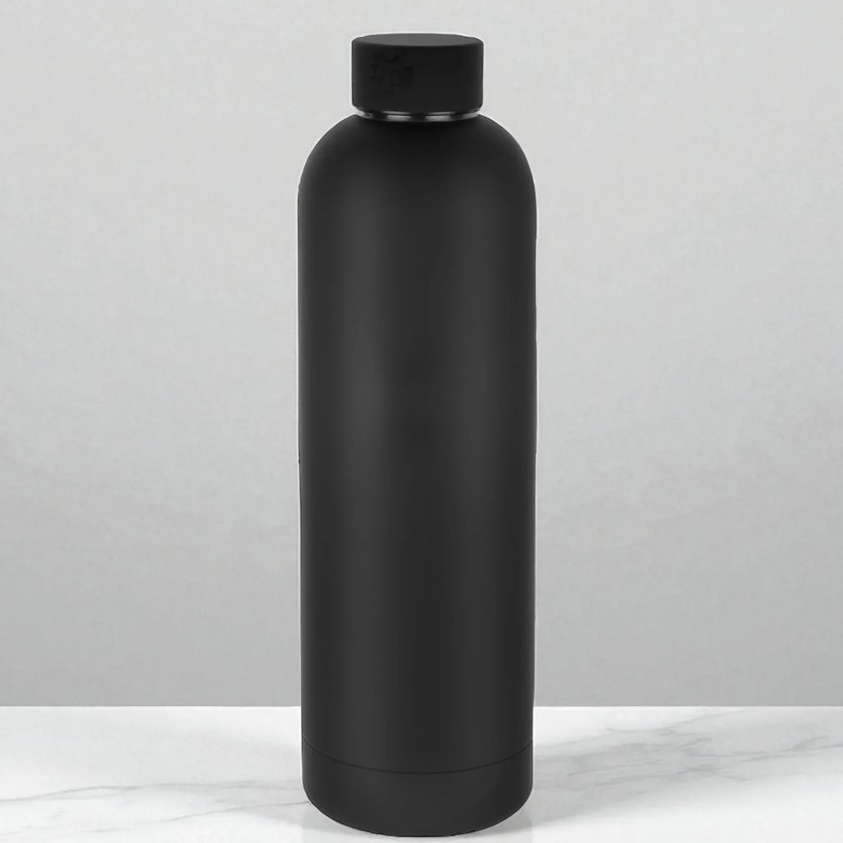 Matte black insulated water bottle on marble surface, modern home accessory