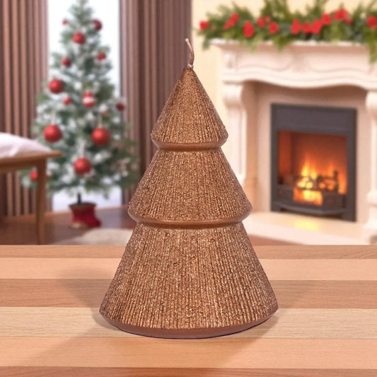 Glittery gold Christmas tree candle on wooden table, festive holiday decor with fireplace and tree background