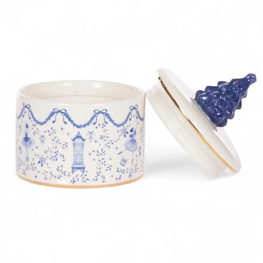 Blue and white ceramic jar with ballerina and clock design, gold trim, Christmas tree knob lid