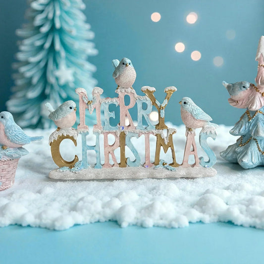 Merry Christmas sign with pastel birds, snow, and festive decor for holiday home styling