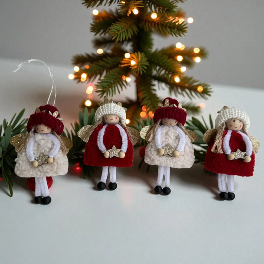 Handcrafted angel ornaments with red and white outfits, golden wings, and star accents, set against a lit Christmas tree.