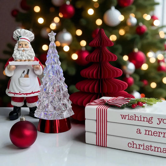 Chef Santa figurine with festive Christmas trees, ornaments, and holiday gift books for home décor