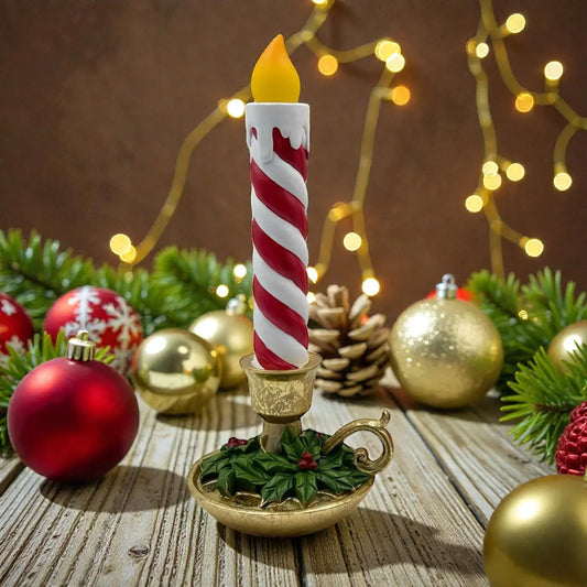 Red and white striped Christmas candle in gold holder with holly, surrounded by ornaments and fairy lights