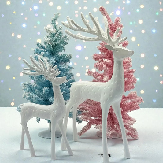 White ceramic reindeer figurines with pastel Christmas trees, festive holiday decor for home