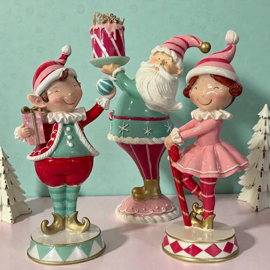 Santa and elf figurines holding cake and gift, festive holiday home decor with candy cane accents