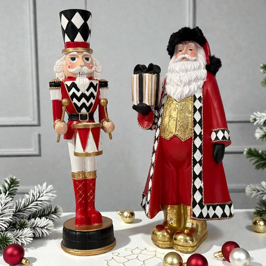 Red and black harlequin Santa and nutcracker figurines with gold accents, festive holiday decor