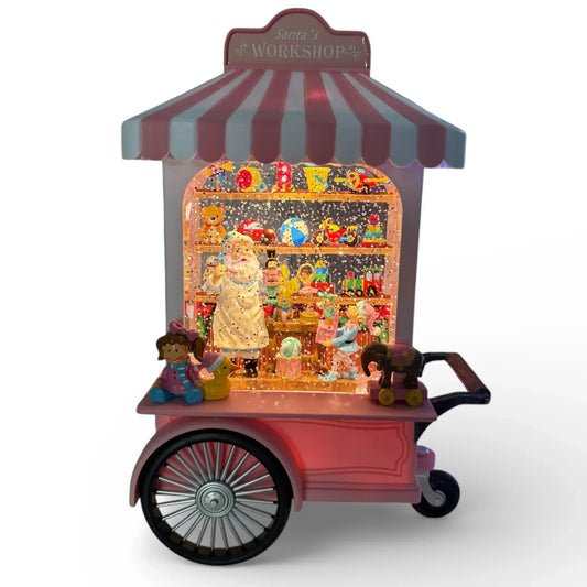 Santa's Workshop snow globe cart with toys, glitter, and festive lights for holiday home décor