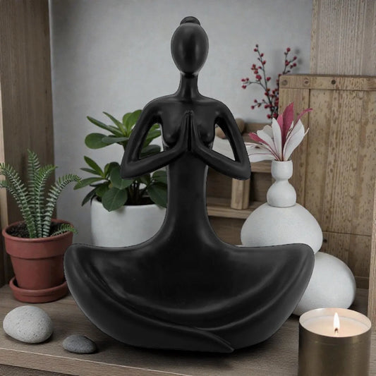 Black meditation statue for zen home décor with plants and candle