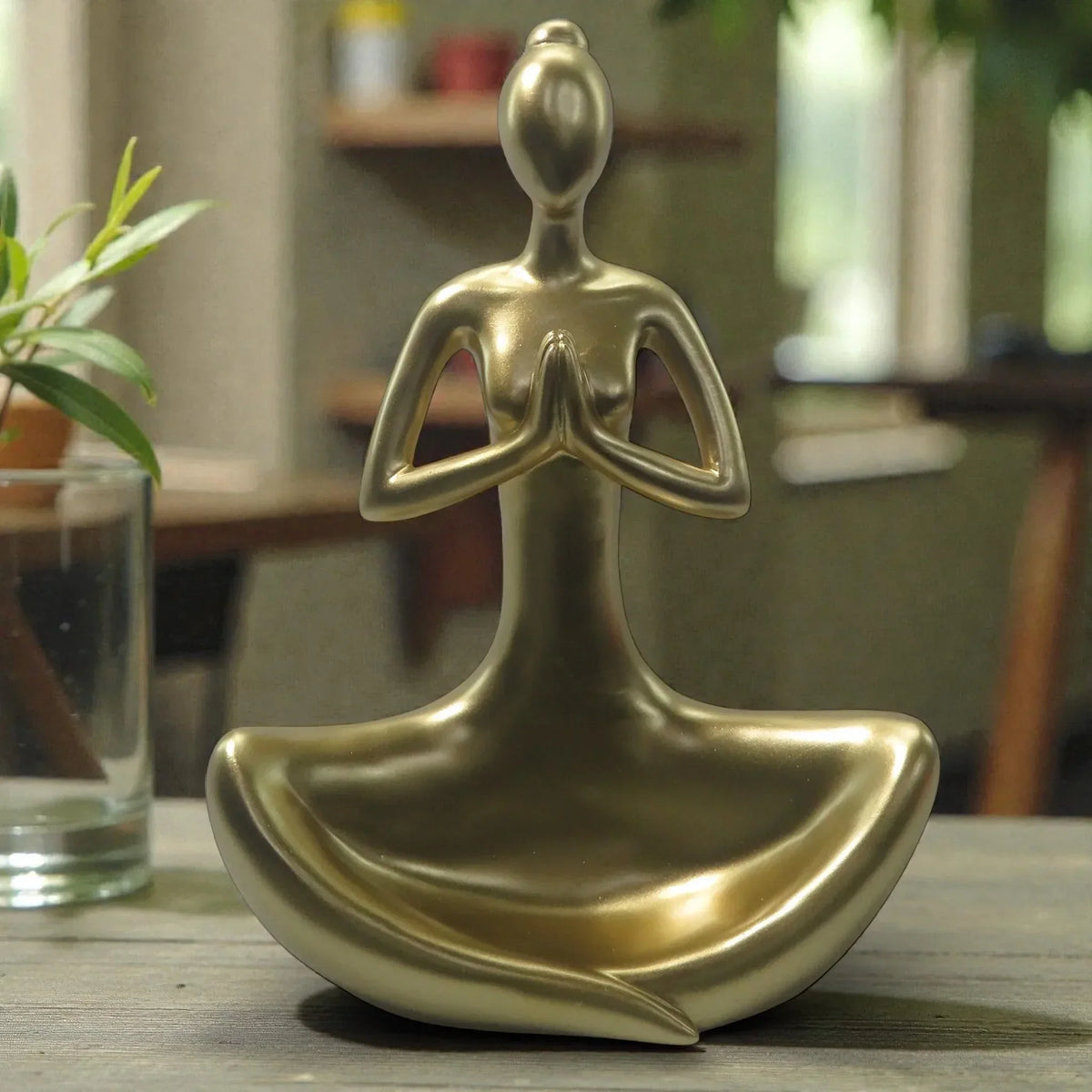 Gold meditation figurine for home décor, yoga statue, zen decor accent on wooden table