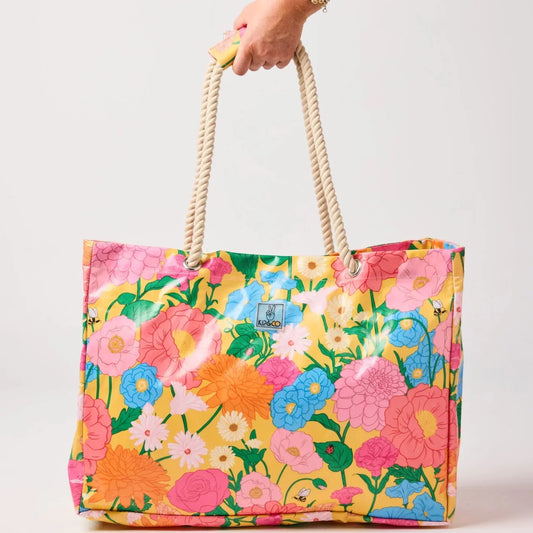 Vibrant floral tote bag with rope handles, perfect for stylish everyday use and home décor accents.