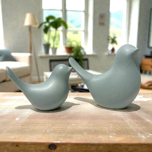 Sleek light blue ceramic bird figurines on wooden table, modern home decor accent pieces