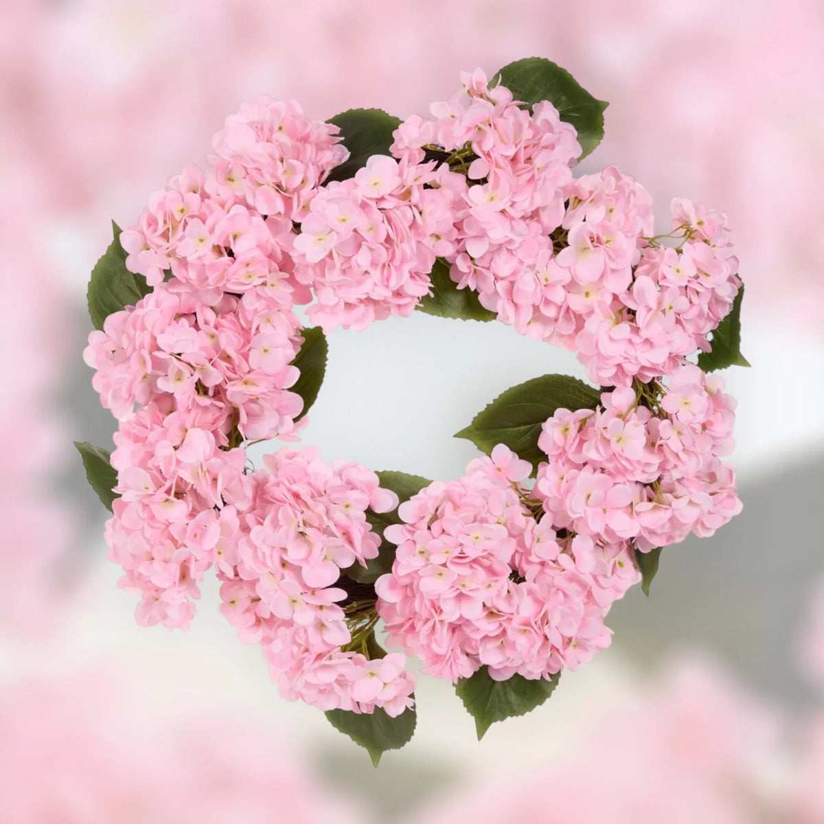 Pink hydrangea heart wreath with green leaves, perfect for home décor and vintage-style interiors.