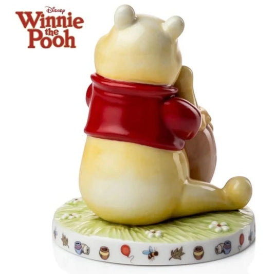 Winnie the Pooh figurine in red shirt, sitting on floral base with honey pots and balloons, Disney collectible home décor