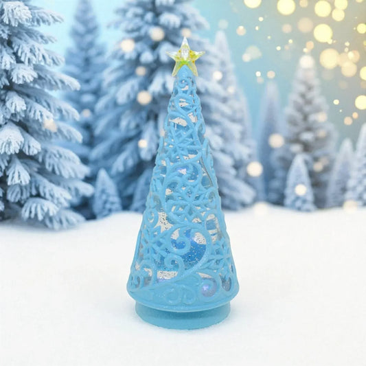 Blue ornate Christmas tree decoration with star topper, set in snowy winter scene