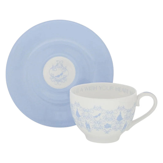 Elegant white teacup with blue Cinderella motifs and matching saucer, perfect for vintage home décor