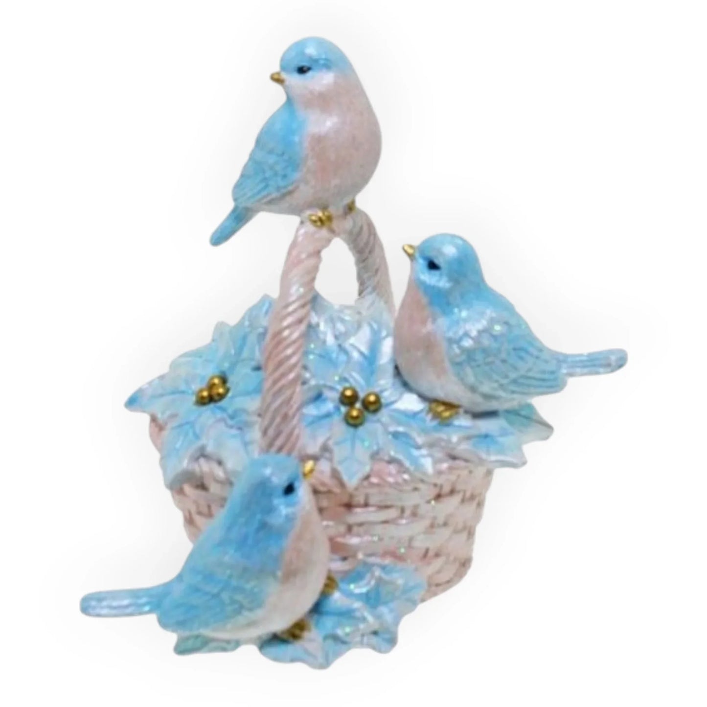 Blue bird figurine set with three birds perched on a woven basket adorned with leaves and berries, perfect for home décor.
