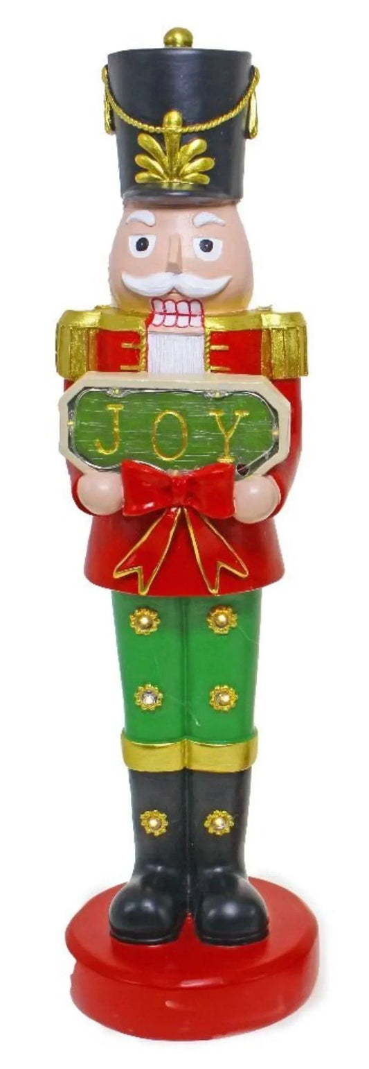 Festive nutcracker figurine holding JOY sign, holiday home décor with red green gold accents
