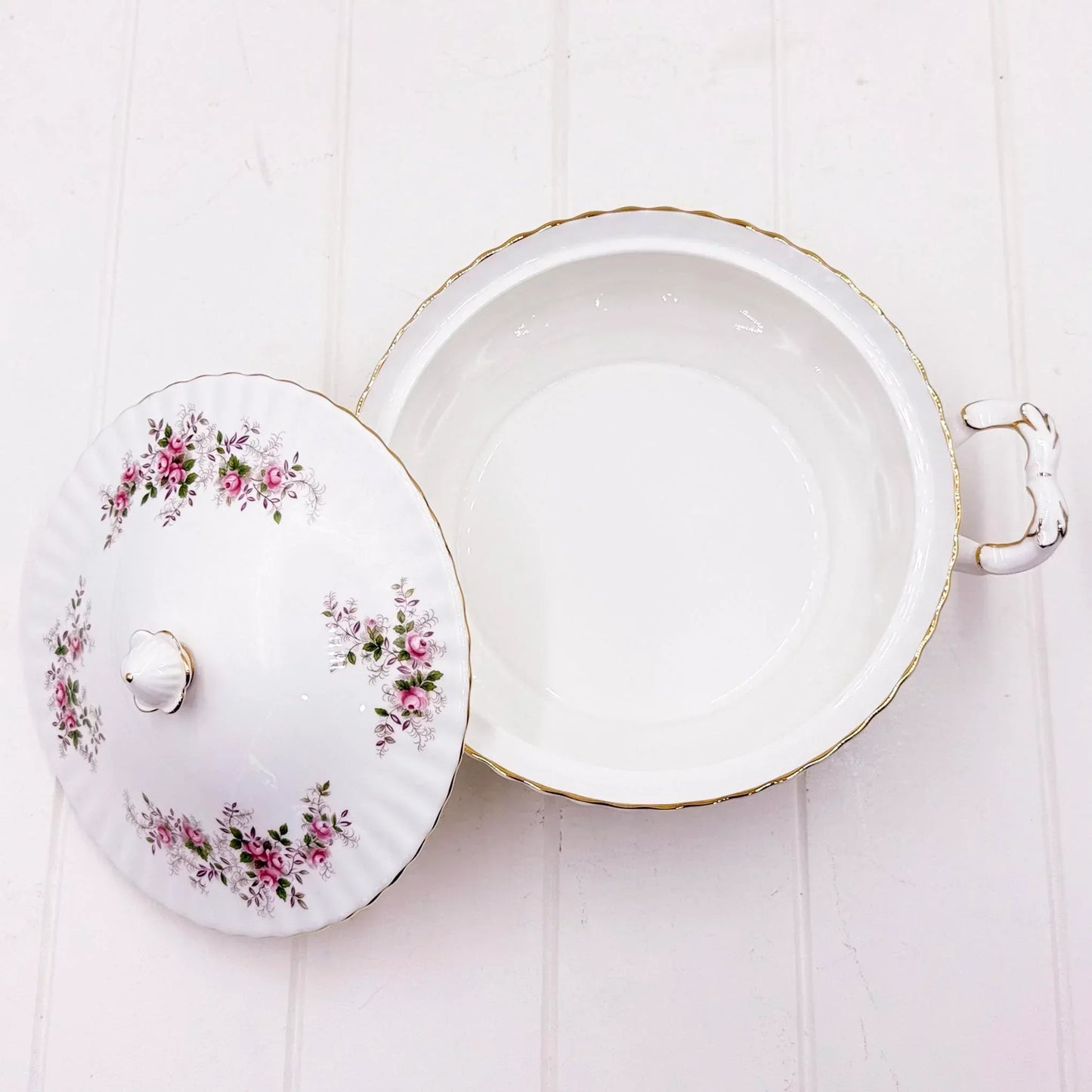 Elegant white porcelain dish with pink rose floral pattern, gold trim, and decorative handle, perfect for vintage home décor.