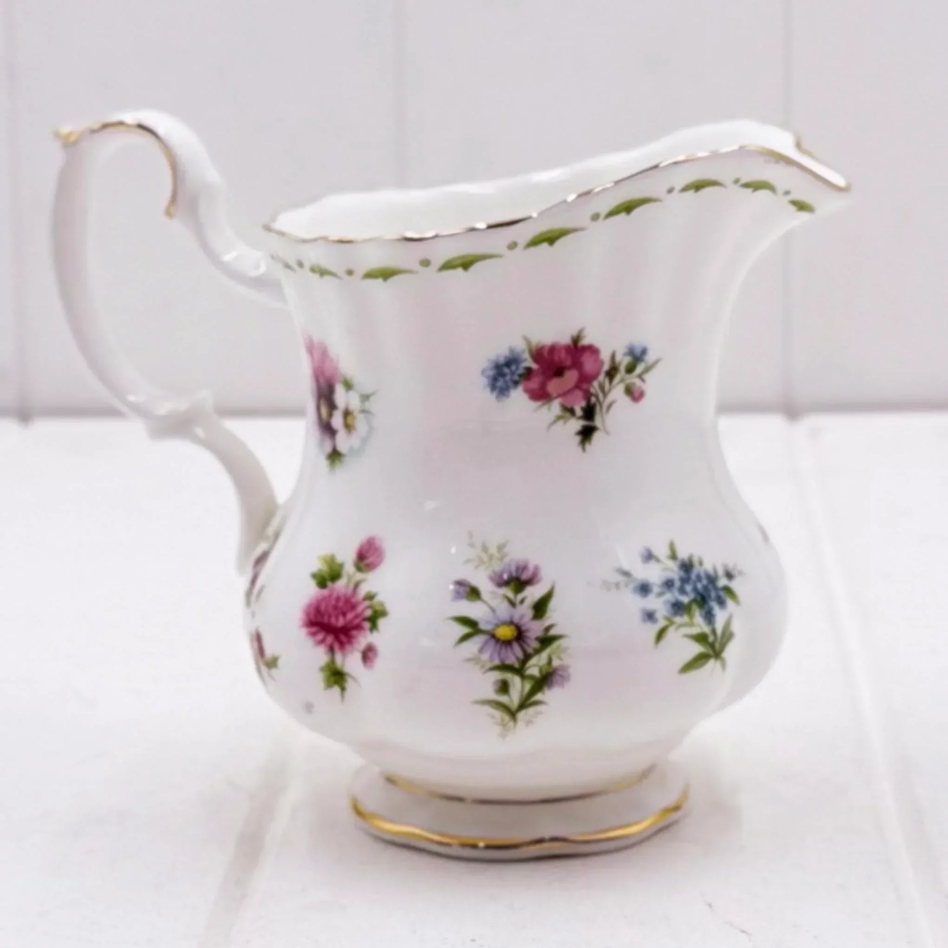 Elegant floral porcelain creamer with gold trim, vintage-style home decor accent piece