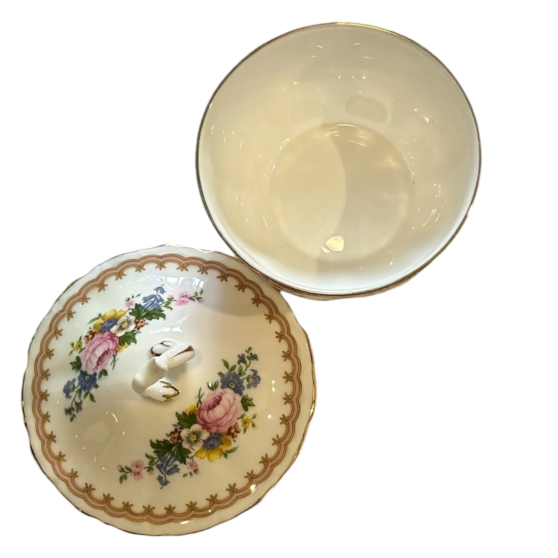 A vintage ceramic lidded bowl set on a white background, showing the glossy cream-colored interior of the bowl and the decorated exterior lid with a floral pattern and gold border.